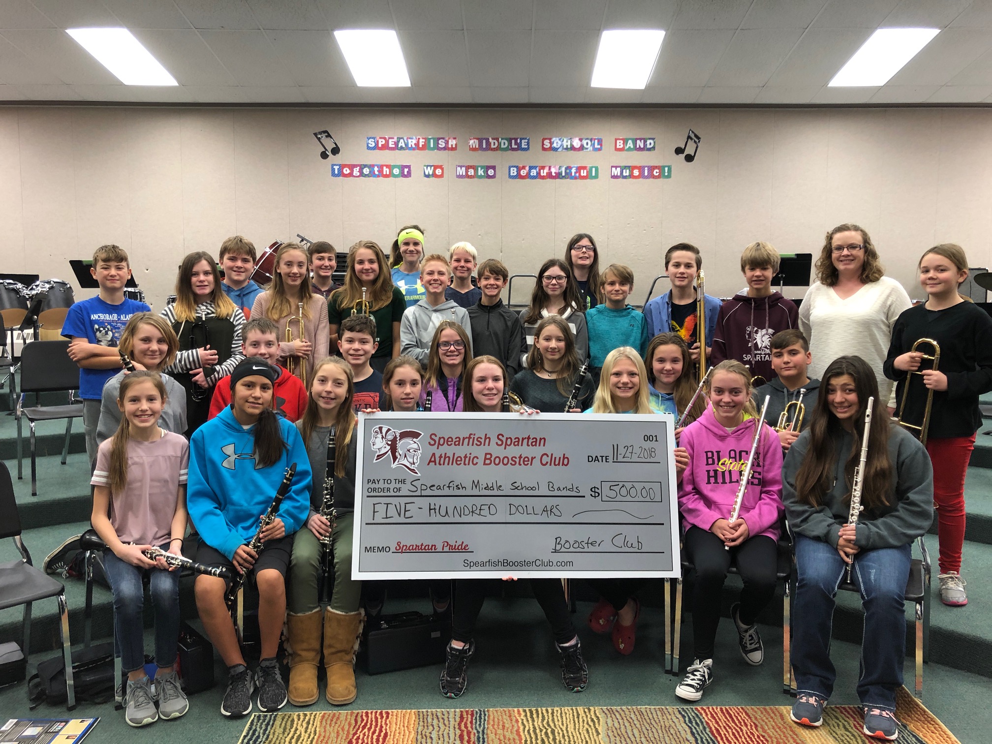 The Spearfish Spartan Athletic Booster Club presented a check in the amount of $500 to the Spearfish Middle School Band Program in gratitude for encouraging students to become involved in band, in hopes that they will continue on with their love of music at the high school level. The Booster Club’s mission is to recognize student athletes and boost school spirit and community pride. Pictured are members of the 7th grade band with Mrs. Case, the middle school band director.
